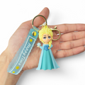 Cartoon Elsa in blue dress holding a snowflake keychain