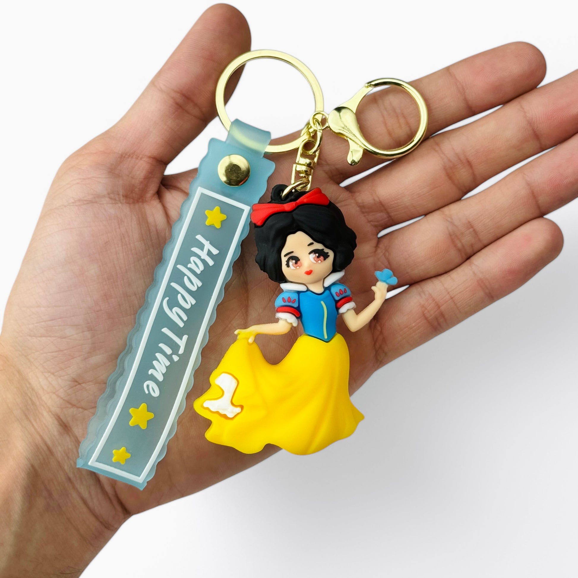 Cartoon Snow White in blue and yellow dress holding a blue bird keychain
